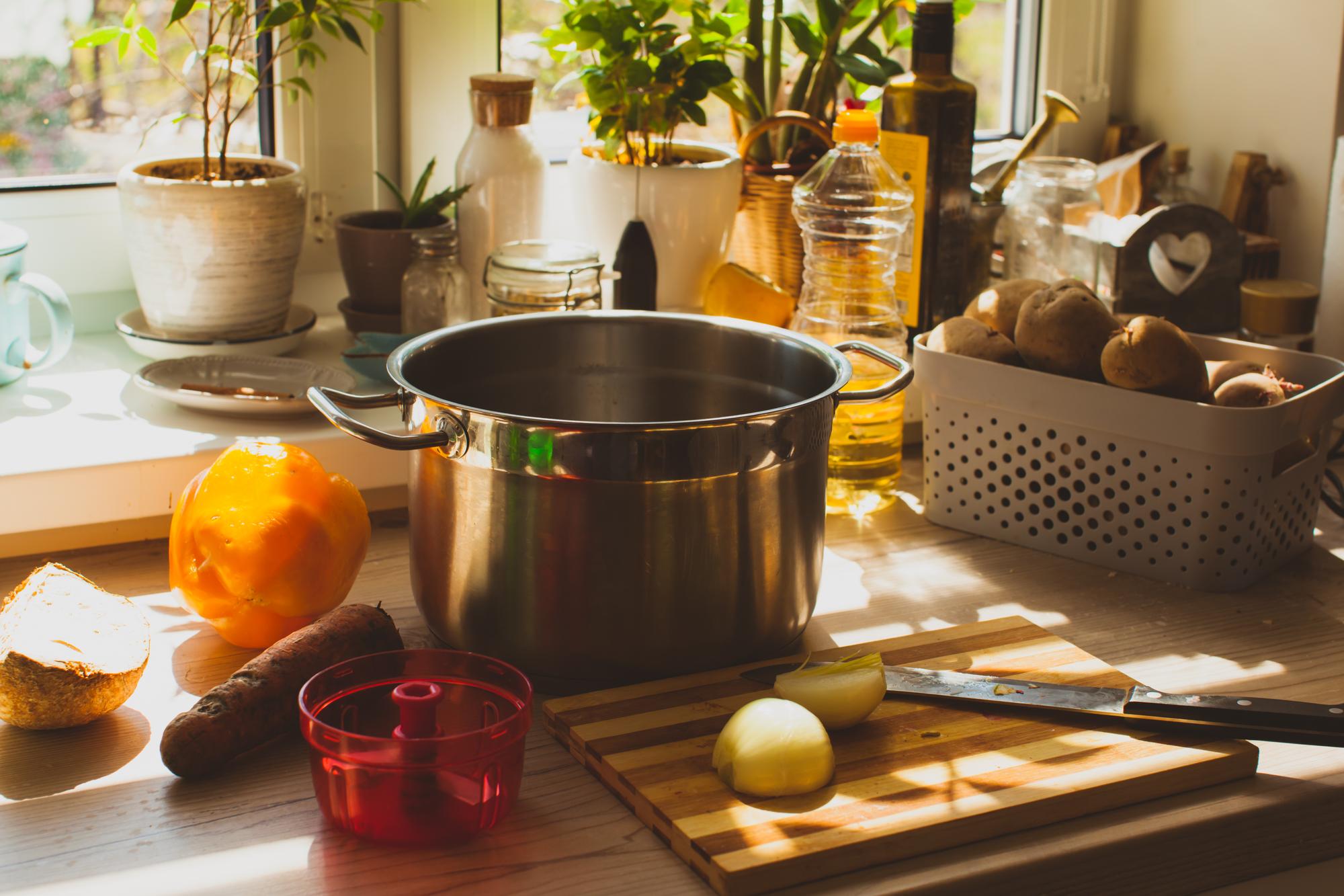 Cozy kitchen workspace with pots and fresh produce
