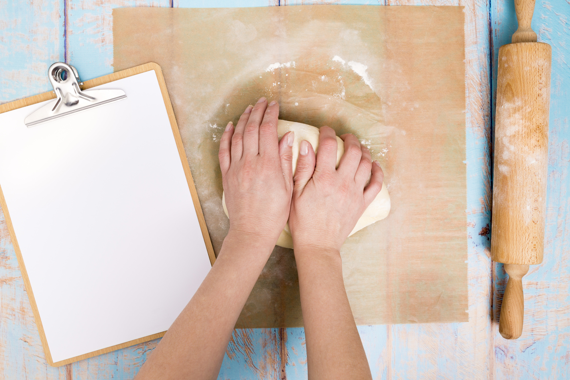 Close-up of hands kneading dough