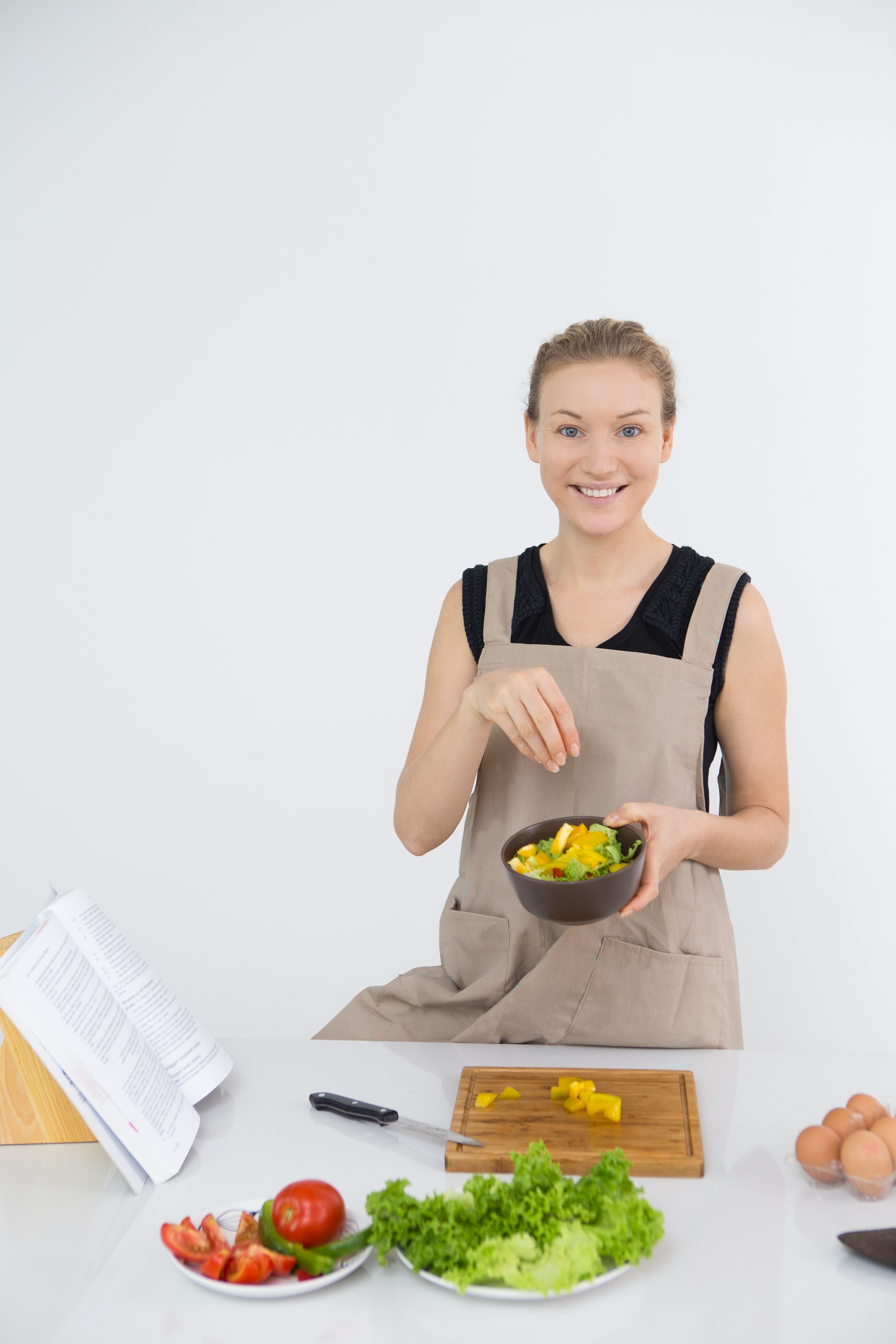 Student plating a composed salad